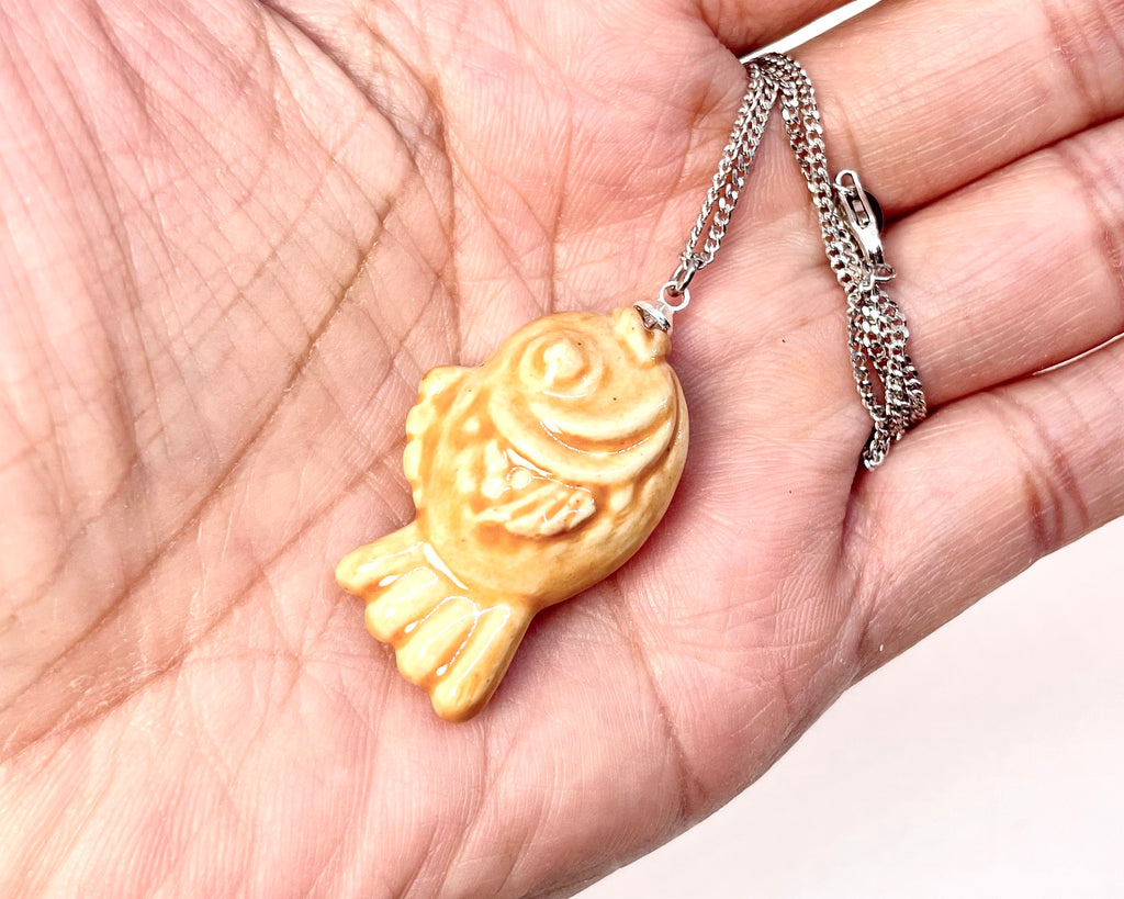 Gold fish-shaped pendant With sterling silver necklace