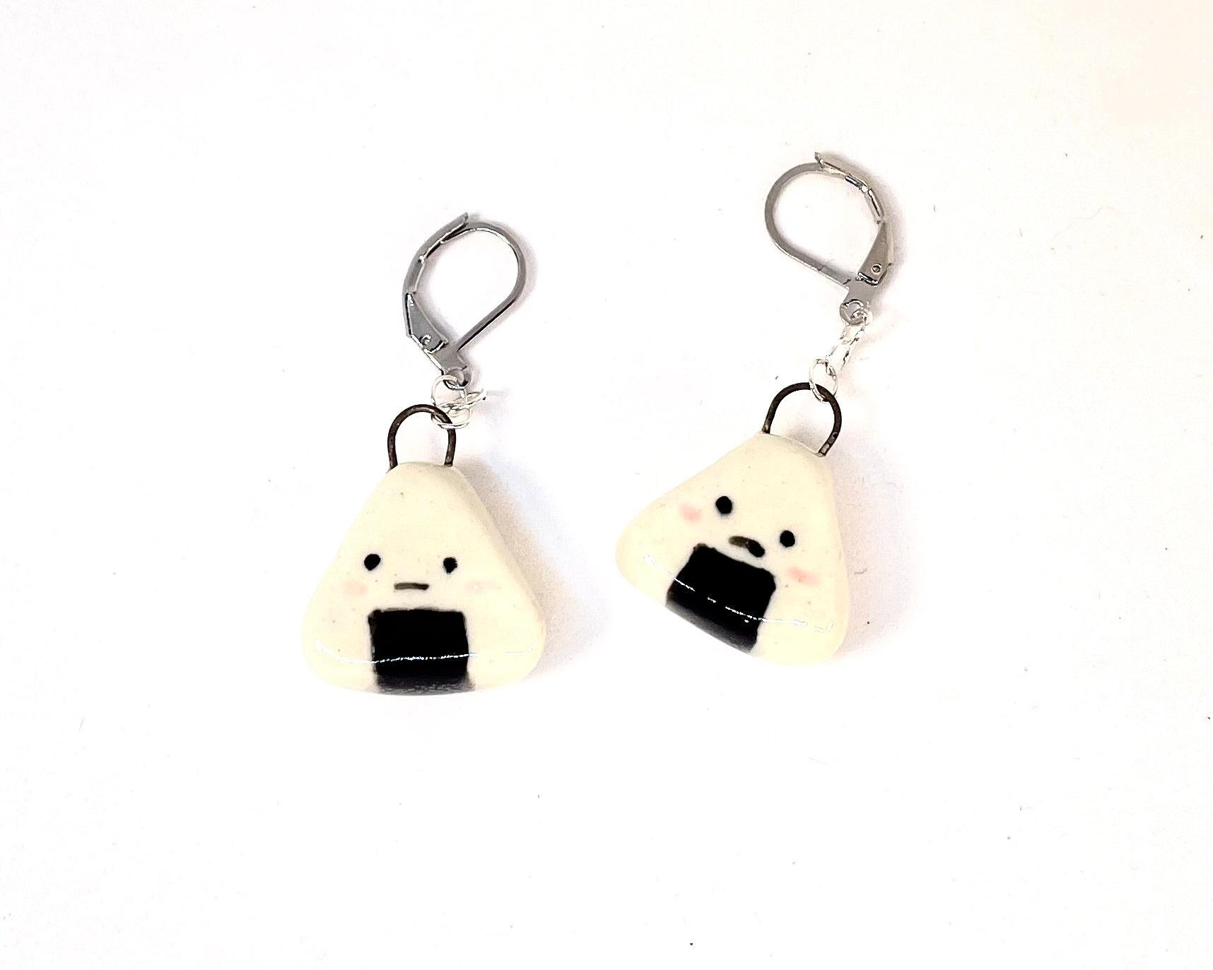 Pair of onigiri-shaped earrings on a white background