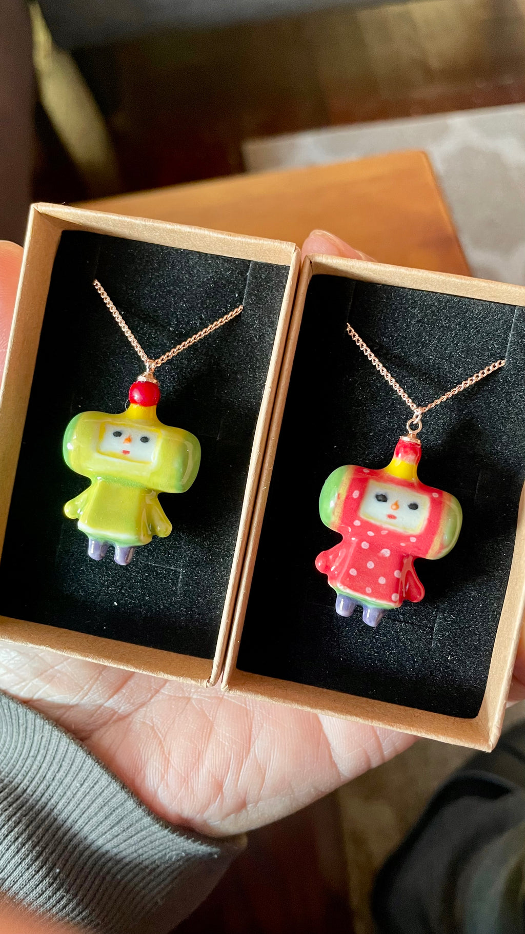 Close-up of a hand-sculpted white porcelain Katamari charm featuring the iconic Prince character.